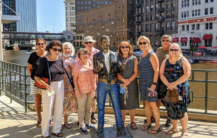 Family standing next to famous Fonz statue along a beautiful river in downtown Milwaukee, Wisconsin